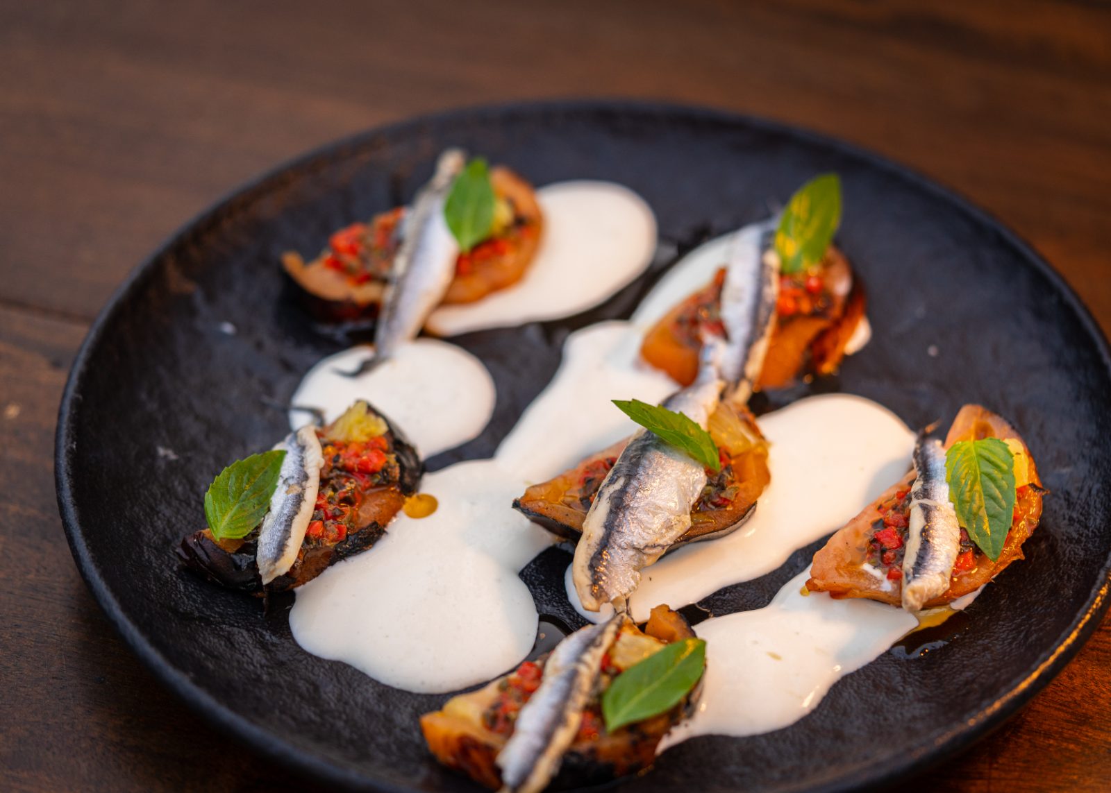 Anchovy and tomato bites with basil